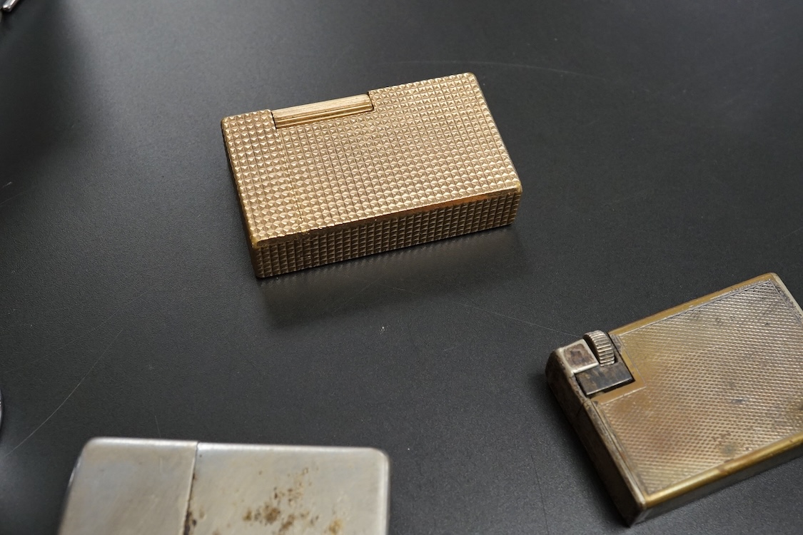 Ten assorted lighters including two Dunhill examples, a Ronson and Dupont, largest 12cm high